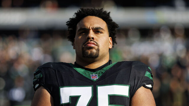 EAST RUTHERFORD, NEW JERSEY - DECEMBER 1: Guard Alijah Vera-Tucker #75 of the New York Jets stands on the sidelines during the national anthem prior to an NFL football game against the Seattle Seahawks, at MetLife Stadium on December 1, 2024 in East Rutherford, New Jersey.