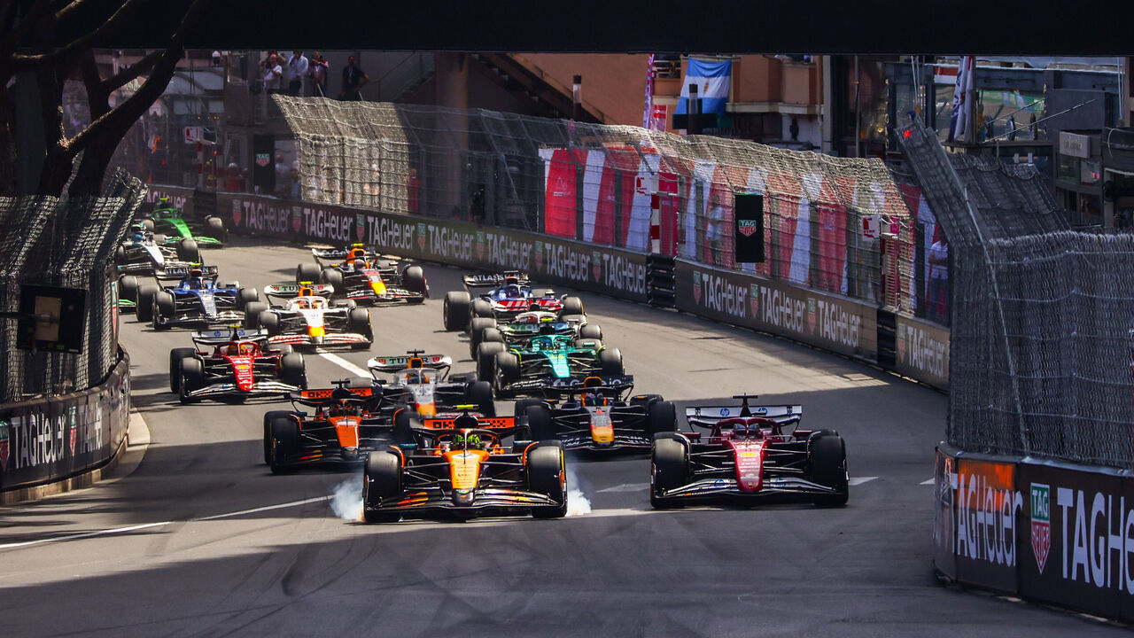 Lando Norris of McLaren and Charles Leclerc of Ferrari during the start of the F1 Grand Prix of Monaco at Circuit de Monaco on May 25, 2025 in Monte-Carlo, Monaco.