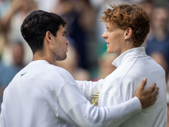 LONDON, ENGLAND - JULY 13: Jannik Sinner of Italy with the winners trophy is congratulated by Carlos Alcaraz of Spain, at the trophy presentations after the Gentlemen's Singles Final on Centre Court during the Wimbledon Lawn Tennis Championships at the All England Lawn Tennis and Croquet Club at Wimbledon on July 13th, 2025, in London, England.