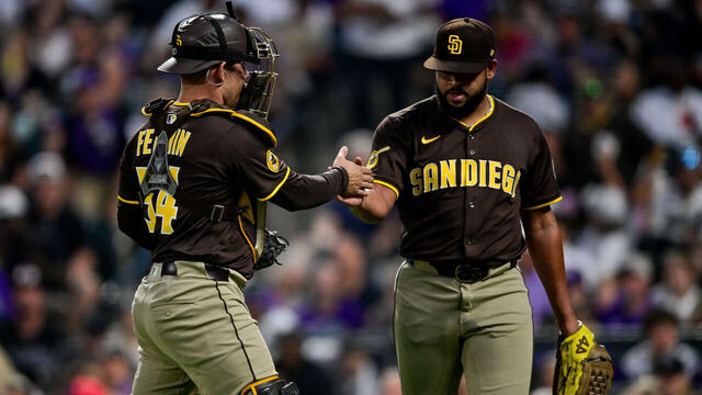 DENVER, CO - SEPTEMBER 6: San Diego Padres pitcher Randy Vasquez (98) celebrates after the fourth inning with catcher Freddy Fermin (54) during a game between the San Diego Padres and the Colorado Rockies at Coors Field on September 6, 2025 in Denver, Colorado.