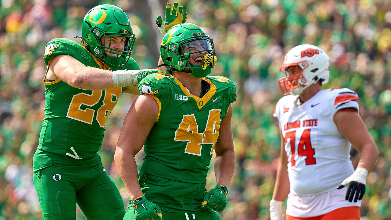 EUGENE, OREGON - SEPTEMBER 6: Teitum Tuioti #44 celebrates with Bryce Boettcher #28 of the Oregon Ducks fter a play during the first half of the game against the Oklahoma State Cowboys at Autzen Stadium on September 6, 2025 in Eugene, Oregon.
