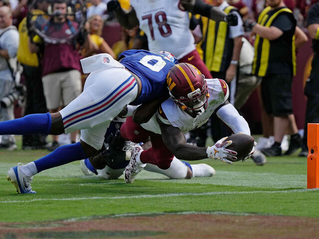 LANDOVER, MARYLAND - SEPTEMBER 07: Deebo Samuel #1 of the Washington Commanders dives for a touchdown during the fourth quarter against the New York Giants at Northwest Stadium on September 07, 2025 in Landover, Maryland.