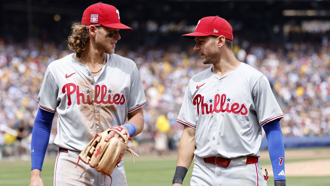 PITTSBURGH, PA - JULY 21: Philadelphia Phillies third baseman Alec Bohm (28) and shortstop Trea Turner (7) talk as they make their way back to the dugout in between innings during an MLB game against the Pittsburgh Pirates on July 21, 2024 at PNC Park in Pittsburgh, Pennsylvania.