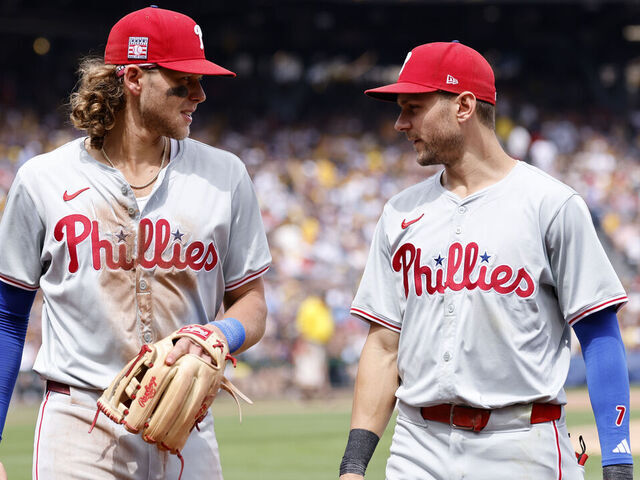 PITTSBURGH, PA - JULY 21: Philadelphia Phillies third baseman Alec Bohm (28) and shortstop Trea Turner (7) talk as they make their way back to the dugout in between innings during an MLB game against the Pittsburgh Pirates on July 21, 2024 at PNC Park in Pittsburgh, Pennsylvania.