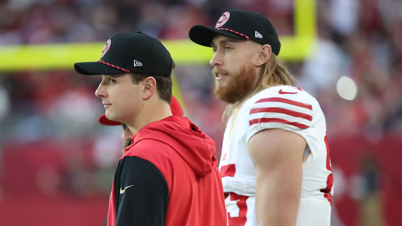 GLENDALE, ARIZONA - JANUARY 5: Injured starting quarterback Brock Purdy #13 of the 49ers watches the play from the sidelines with teammate George Kittle #85 in the third quarter of the San Francisco 49ers versus the Arizona Cardinals NFL football game at State Farm Stadium on January 5, 2025 in Glendale, Arizona.