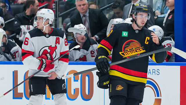 VANCOUVER, CANADA - OCTOBER 30: Jack Hughes #86 of the New Jersey Devils and Quinn Hughes #43 of the Vancouver Canucks waits for a face-off during the first period of their NHL game at Rogers Arena on October 30, 2024 in Vancouver, British Columbia, Canada.