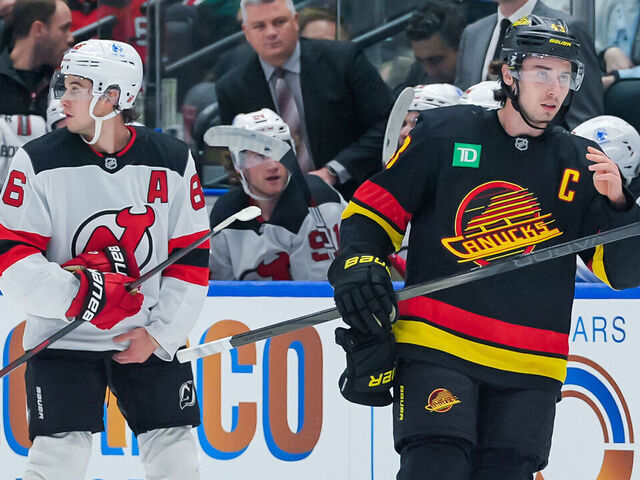 VANCOUVER, CANADA - OCTOBER 30: Jack Hughes #86 of the New Jersey Devils and Quinn Hughes #43 of the Vancouver Canucks waits for a face-off during the first period of their NHL game at Rogers Arena on October 30, 2024 in Vancouver, British Columbia, Canada.