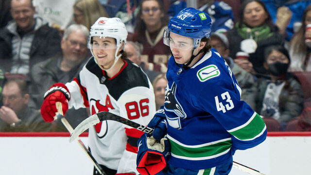 VANCOUVER, BC - MARCH 15: Vancouver Canucks defenseman Quinn Hughes (43) and New Jersey Devils center Jack Hughes (86) after a whistle during their NHL game at Rogers Arena on March 15, 2022 in Vancouver, British Columbia, Canada.