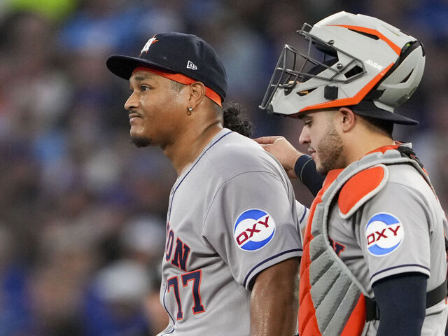 TORONTO, CANADA - SEPTEMBER 9: Luis Garcia #77 of the Houston Astros returns to the pitching mound with teammate Yainer Diaz #21 during the second inning in their MLB game against the Toronto Blue Jays at Rogers Centre on September 9, 2025 in Toronto, Canada.