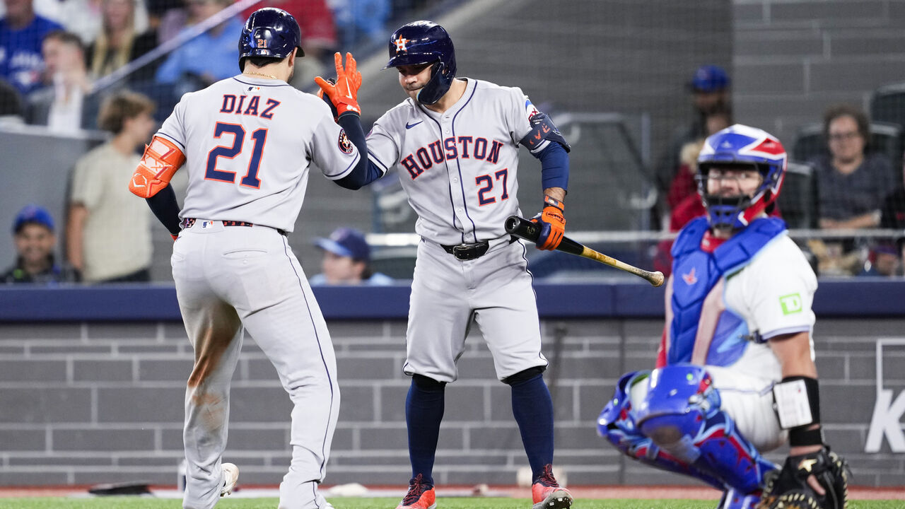 TORONTO, CANADA - SEPTEMBER 10: Yainer Diaz #21 of the Houston Astros celebrates his home run with Jose Altuve #27 against the Toronto Blue Jays during the ninth inning in their MLB game at the Rogers Centre on September 10, 2025 in Toronto, Ontario, Canada.