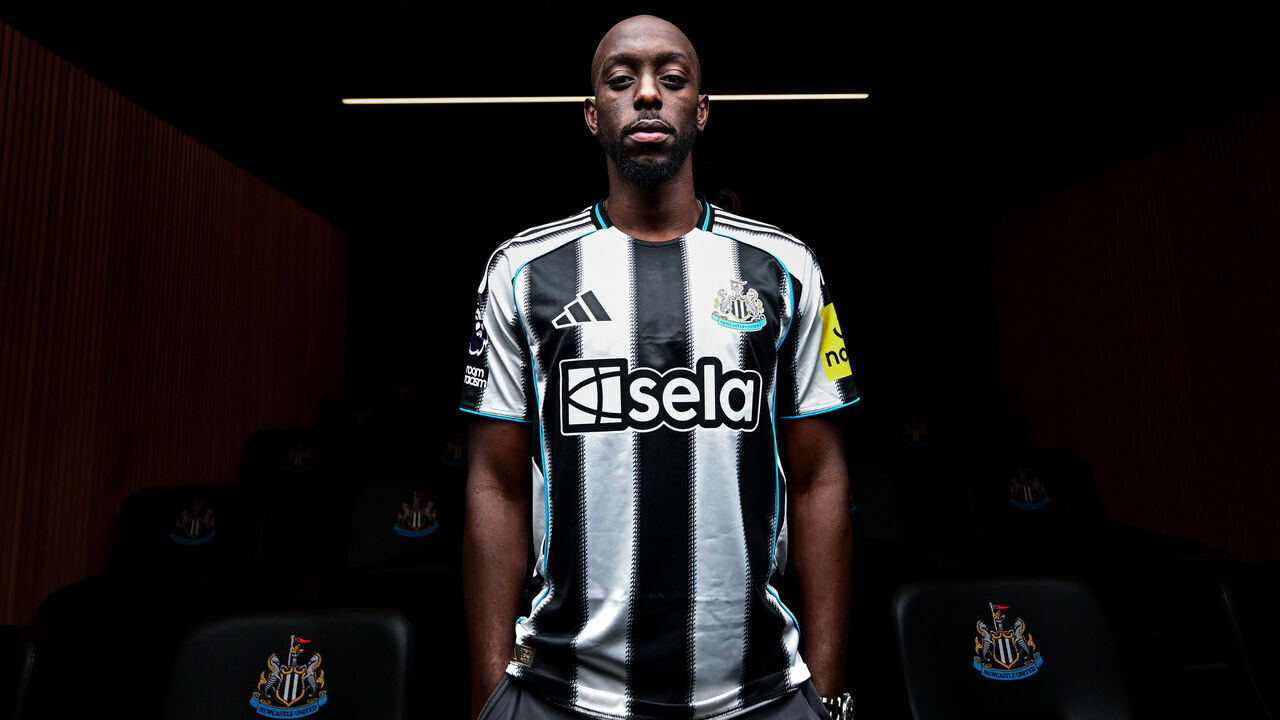 NEWCASTLE UPON TYNE, ENGLAND - SEPTEMBER 01: Yoane Wissa poses for photographs wearing a home shirt at the Newcastle United Training Centre after signing for the club on September 01, 2025 in Newcastle upon Tyne, England.