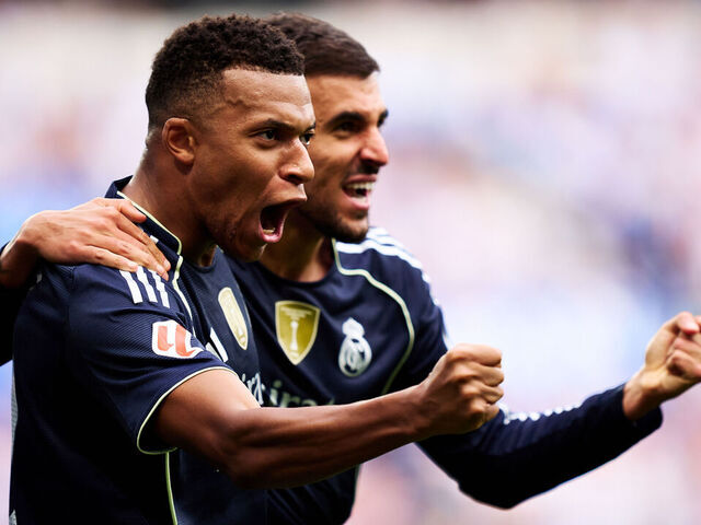 SAN SEBASTIAN, SPAIN - SEPTEMBER 13: Kylian Mbappe of Real Madrid celebrates after scoring their side's second goal with his teammate Daniel Ceballos of Real Madrid during the LaLiga EA Sports match between Real Sociedad and Real Madrid CF at Reale Arena on September 13, 2025 in San Sebastian, Spain.