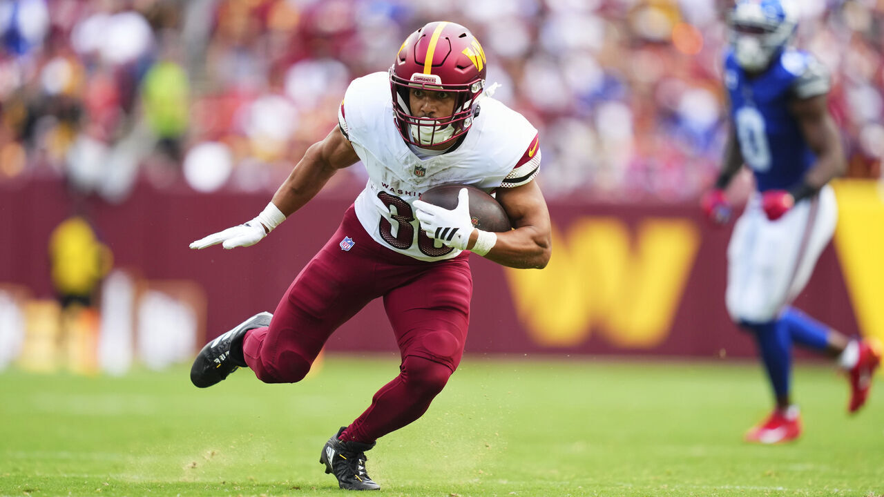 LANDOVER, MD - SEPTEMBER 07: Austin Ekeler #30 of the Washington Commanders carries the ball against the New York Giants during an NFL football game at Northwest Stadium on September 7, 2025 in Landover, Maryland.