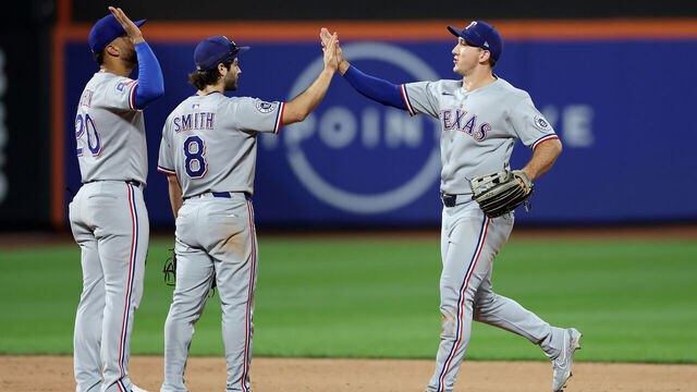 NEW YORK, NEW YORK - SEPTEMBER 13: Ezequiel Duran #20, Josh Smith #8 and Wyatt Langford #36 of the Texas Rangers celebrate the win over the New York Mets at Citi Field on September 13, 2025 in the Flushing neighborhood of the Queens borough of New York City. The Texas Rangers defeated the New York Mets 3-2.