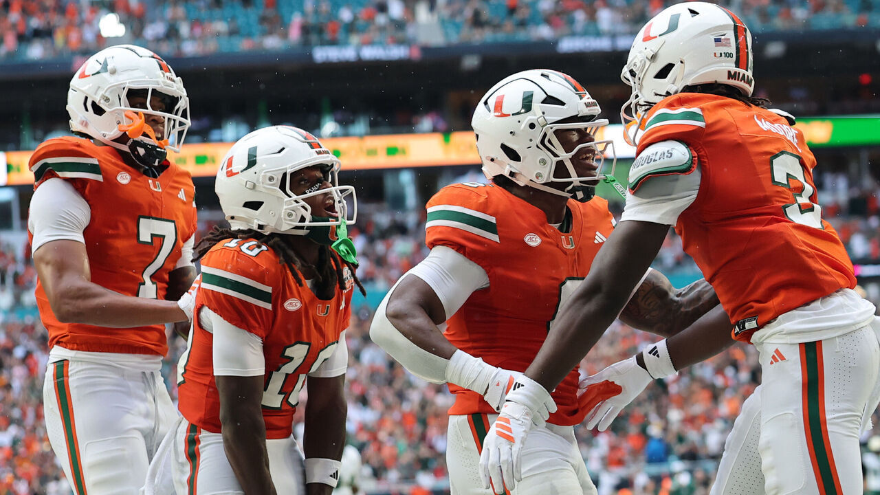 MIAMI GARDENS, FLORIDA - SEPTEMBER 13: Joshua Moore #3 of the Miami Hurricanes celebrates with Malachi Toney #10, and Damari Brown #6 following his reception for a touchdown against the South Florida Bulls during the first half at Hard Rock Stadium on September 13, 2025 in Miami Gardens, Florida.