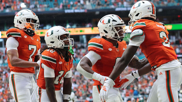 MIAMI GARDENS, FLORIDA - SEPTEMBER 13: Joshua Moore #3 of the Miami Hurricanes celebrates with Malachi Toney #10, and Damari Brown #6 following his reception for a touchdown against the South Florida Bulls during the first half at Hard Rock Stadium on September 13, 2025 in Miami Gardens, Florida.