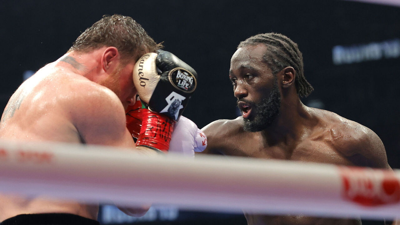 LAS VEGAS, NEVADA - SEPTEMBER 13: Terence Crawford (R) lands a right on Canelo Alvarez in their undisputed super middleweight title fight during Netflix's Canelo v Crawford Fight Night at Allegiant Stadium on September 13, 2025 in Las Vegas, Nevada.