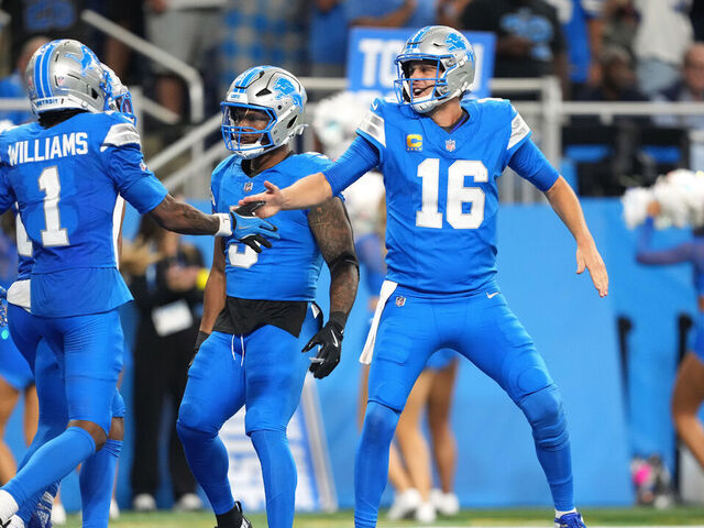 DETROIT, MICHIGAN - SEPTEMBER 14: Jared Goff #16 of the Detroit Lions celebrates after Jameson Williams #1 scores a touchdown in the second half of the game against the Chicago Bears at Ford Field on September 14, 2025 in Detroit, Michigan.