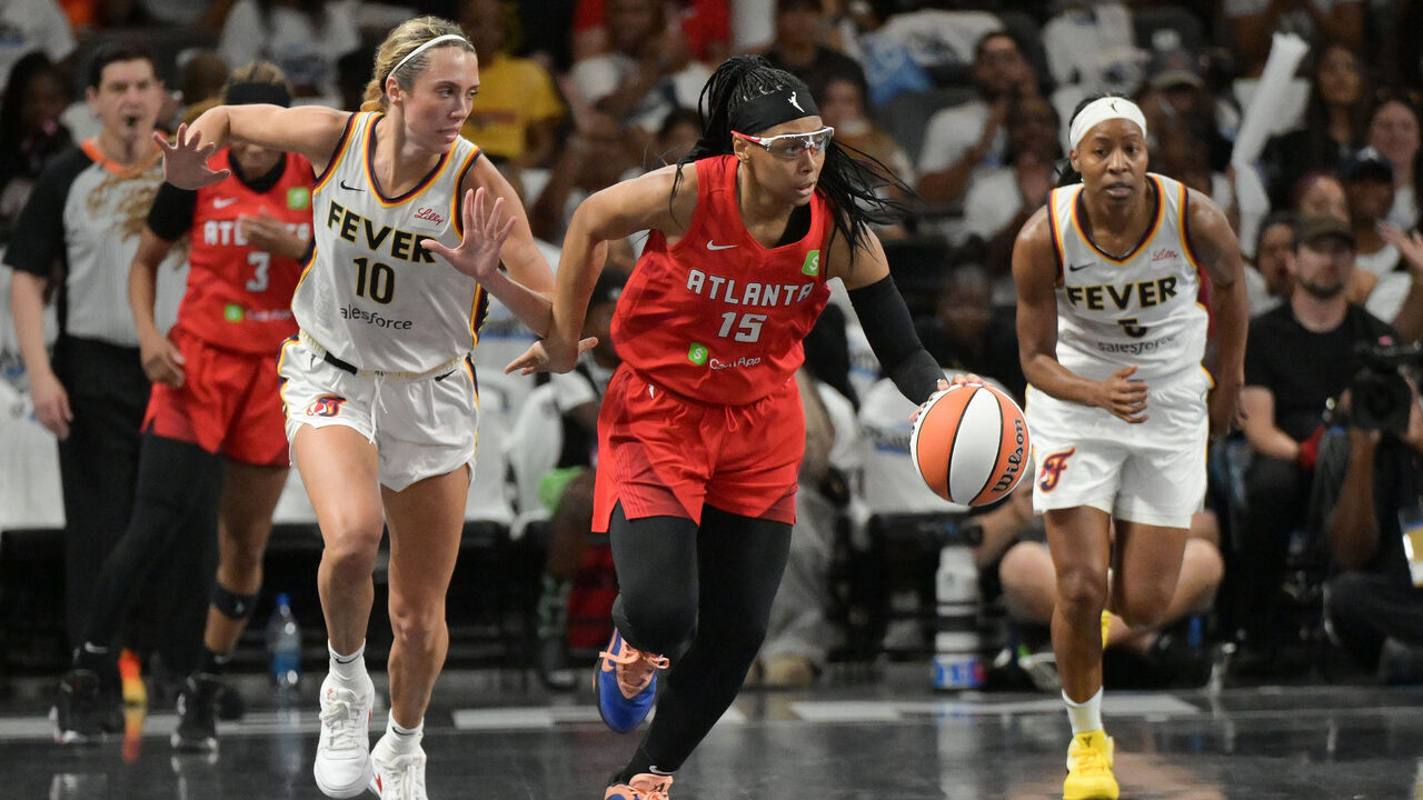 COLLEGE PARK, GEORGIA - SEPTEMBER 14: Allisha Gray #15 of the Atlanta Dream drives the ball as Lexie Hull #10 and Shey Peddy #5 of the Indiana Fever play defense during second quarter at game one of the first round of WNBA Playoffs at Gateway Center Arena on September 14, 2025 in College Park, Georgia.