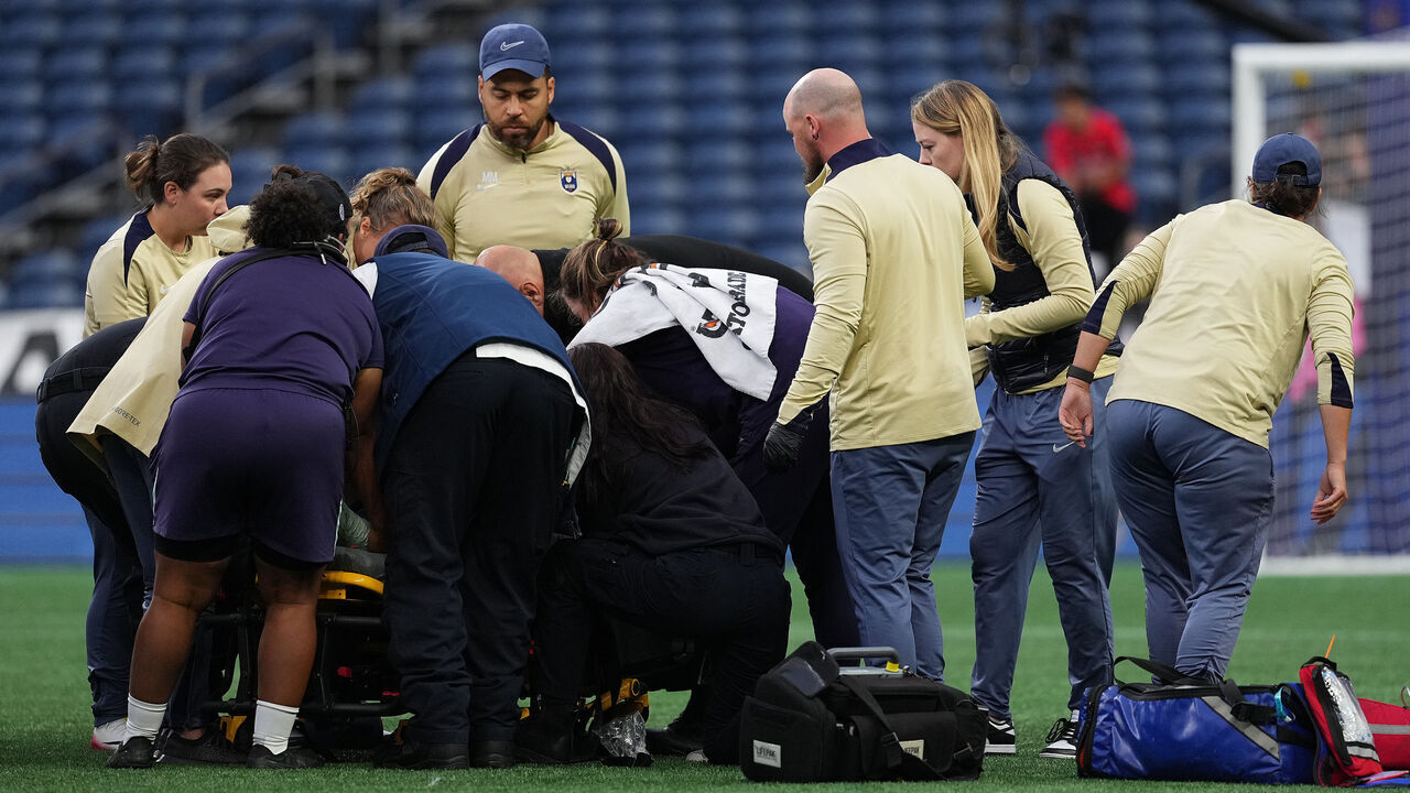 SEATTLE, WASHINGTON - SEPTEMBER 14: Savannah DeMelo #7 of Racing Louisville FC receives medical attention during the NWSL match between Seattle Reign and Racing Louisville at Lumen Field on September 14, 2025 in Seattle, Washington.