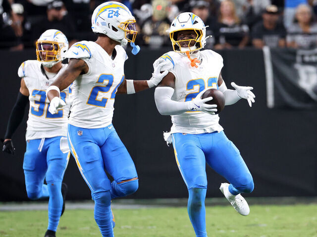 LAS VEGAS, NEVADA - SEPTEMBER 15: Tony Jefferson #23 of the Los Angeles Chargers reacts with Benjamin St-Juste #24 after intercepting a pass intended for Dont'e Thornton Jr. #10 of the Las Vegas Raiders during the second quarter at Allegiant Stadium on September 15, 2025 in Las Vegas, Nevada.