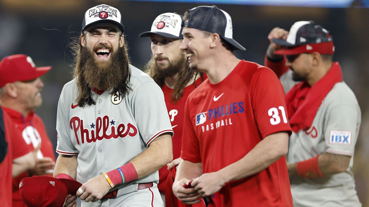LOS ANGELES, CALIFORNIA - SEPTEMBER 15: Brandon Marsh #16 and Walker Buehler #31 of the Philadelphia Phillies celebrate after clinching the NL East after defeating the Los Angeles Dodgers 6-5 at Dodger Stadium on September 15, 2025 in Los Angeles, California.