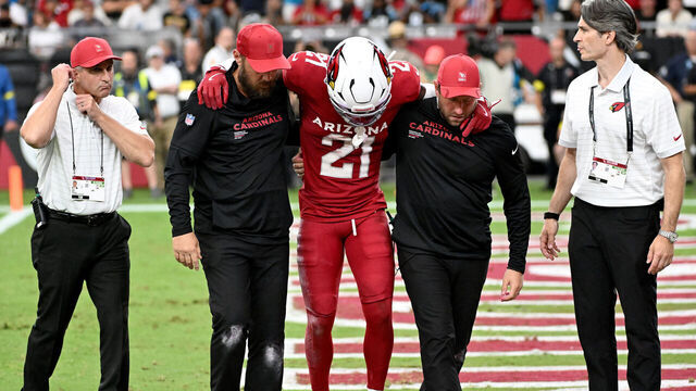 GLENDALE, ARIZONA - SEPTEMBER 14: Garrett Williams #21 of the Arizona Cardinals is helped off the field after sustaining an injury during the fourth quarter against the Carolina Panthers at State Farm Stadium on September 14, 2025 in Glendale, Arizona.