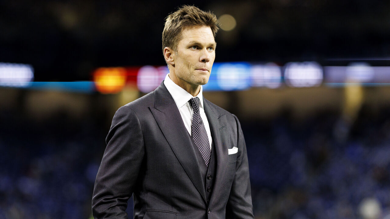 DETROIT, MICHIGAN - JANUARY 18: Fox Sports commentator Tom Brady stands on the field prior to the NFC Divisional Playoff game between the Washington Commanders and the Detroit Lions, at Ford Field on January 18, 2025 in Detroit, Michigan.