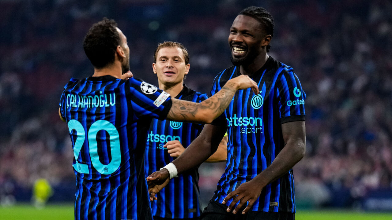 AMSTERDAM, NETHERLANDS - SEPTEMBER 17: Marcus Thuram of FC Internazionale celebrates with Hakan Calhanoglu of FC Internazionale after scoring his team's second goal during the UEFA Champions League 2025/26 League Phase MD1 match between AFC Ajax and FC Internazionale Milano at Johan Cruijff Arena on September 17, 2025 in Amsterdam, Netherlands.