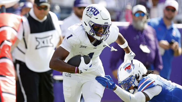 FORT WORTH, TEXAS - SEPTEMBER 20: Eric McAlister #1 of the TCU Horned Frogs eludes Jaelyn Davis-Robinson #13 of the SMU Mustangs before scoring a touchdown against the SMU Mustangs during the first half at Amon G. Carter Stadium on September 20, 2025 in Fort Worth, Texas.
