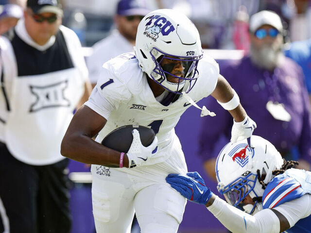 FORT WORTH, TEXAS - SEPTEMBER 20: Eric McAlister #1 of the TCU Horned Frogs eludes Jaelyn Davis-Robinson #13 of the SMU Mustangs before scoring a touchdown against the SMU Mustangs during the first half at Amon G. Carter Stadium on September 20, 2025 in Fort Worth, Texas.