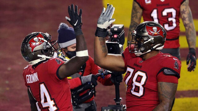 LANDOVER, MARYLAND - JANUARY 09: Wide receiver Chris Godwin #14 of the Tampa Bay Buccaneers is congratulated by offensive tackle Tristan Wirfs #78 after a touchdown during the 2nd quarter of the game against the Washington Football Team at FedExField on January 09, 2021 in Landover, Maryland.