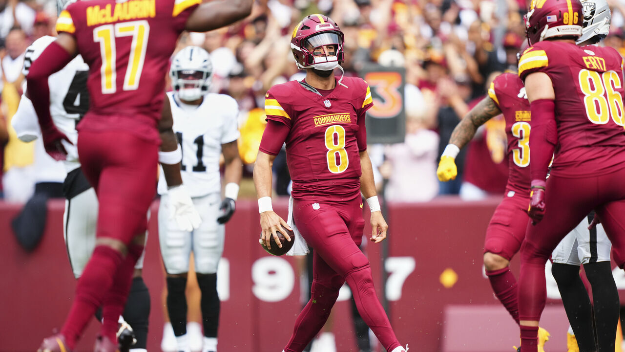 LANDOVER, MD - SEPTEMBER 21: Marcus Mariota #8 of the Washington Commanders celebrates after scoring a touchdown against the Las Vegas Raiders during the first half of an NFL football game at Northwest Stadium on September 21, 2025 in Landover, Maryland.