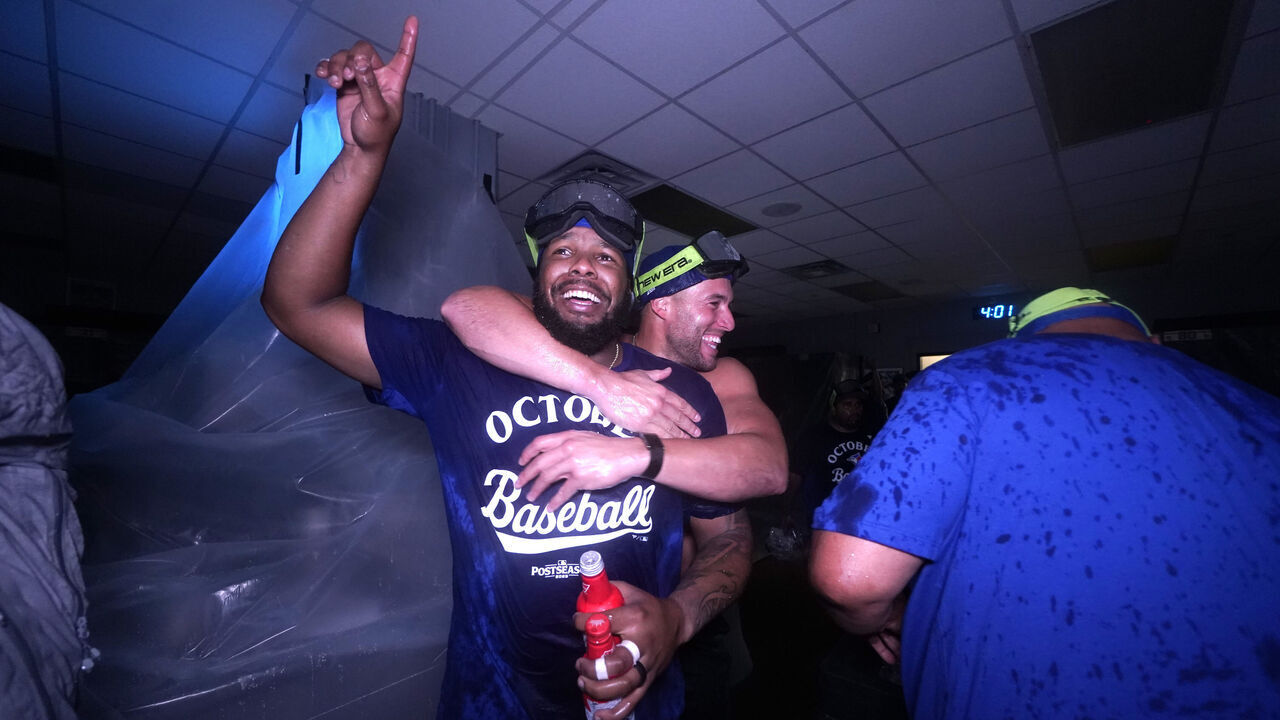 KANSAS CITY, MISSOURI - SEPTEMBER 21: Vladimir Guerrero Jr. #27 and George Springer #4 of the Toronto Blue Jays celebrate after clinching a playoff berth at Kauffman Stadium on September 21, 2025 in Kansas City, Missouri.