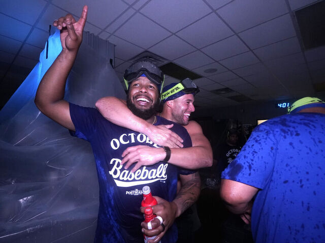KANSAS CITY, MISSOURI - SEPTEMBER 21: Vladimir Guerrero Jr. #27 and George Springer #4 of the Toronto Blue Jays celebrate after clinching a playoff berth at Kauffman Stadium on September 21, 2025 in Kansas City, Missouri.