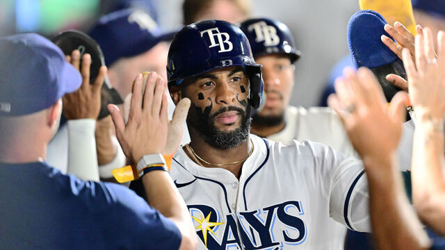 TAMPA, FLORIDA - SEPTEMBER 21: Yandy Díaz #2 of the Tampa Bay Rays celebrates with teammates in the dugout after scoring in the first inning against the Boston Red Sox at George M. Steinbrenner Field on September 21, 2025 in Tampa, Florida.