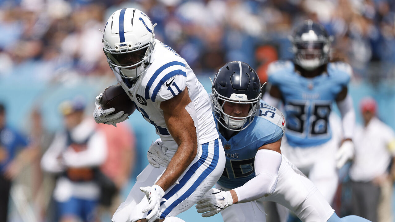 NASHVILLE, TN - SEPTEMBER 21: Indianapolis Colts wide receiver Michael Pittman (11) breaks the tackle attempt by Tennessee Titans linebacker Cody Barton (50) during an NFL game between the Indianapolis Colts and the Tennessee Titans on September 21, 2025 at Nissan Stadium in Nashville, TN.