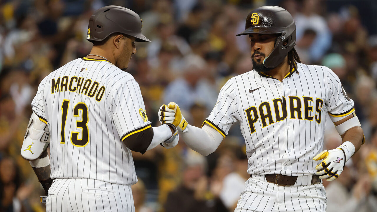 San Diego, CA - September 10, 2025: Fernando Tatis Jr. #23 of the San Diego Padres celebrates with Manny Machado #13 after hitting a solo home run in the fifth inning against the Cincinnati Reds at Petco Park on September 10, 2025 in San Diego, California. (K.C. Alfred / The San Diego Union-Tribune via Getty Images)