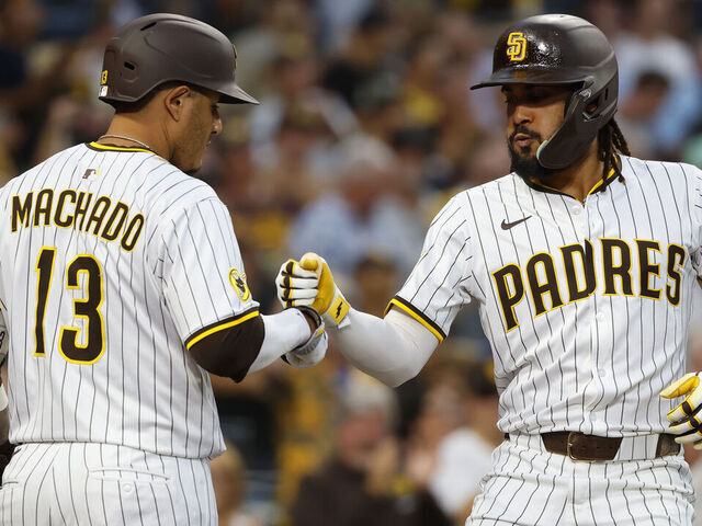 San Diego, CA - September 10, 2025: Fernando Tatis Jr. #23 of the San Diego Padres celebrates with Manny Machado #13 after hitting a solo home run in the fifth inning against the Cincinnati Reds at Petco Park on September 10, 2025 in San Diego, California. (K.C. Alfred / The San Diego Union-Tribune via Getty Images)