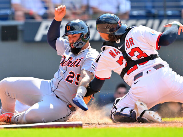 CLEVELAND, OHIO - JULY 06: Gleyber Torres #25 of the Detroit Tigers scores as catcher Bo Naylor #23 of the Cleveland Guardians tries to make the tag during the tenth inning at Progressive Field on July 06, 2025 in Cleveland, Ohio.