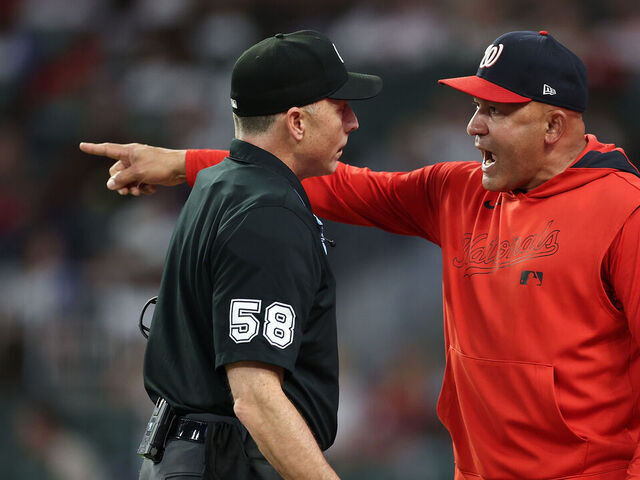 ATLANTA, GEORGIA - SEPTEMBER 22: Interim manager Miguel Cairo #22 of the Washington Nationals reacts to homeplate umpire Dan Iassogna #58 after being ejected by first base umpire Manny Gonzalez #79 in the third inning against the Atlanta Braves at Truist Park on September 22, 2025 in Atlanta, Georgia.
