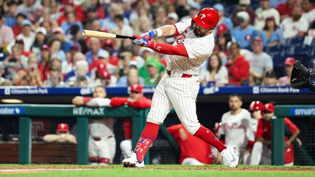 PHILADELPHIA, PENNSYLVANIA - SEPTEMBER 24: Kyle Schwarber #12 of the Philadelphia Phillies makes a hit during the seventh inning against the Miami Marlins at Citizens Bank Park on September 24, 2025 in Philadelphia, Pennsylvania.