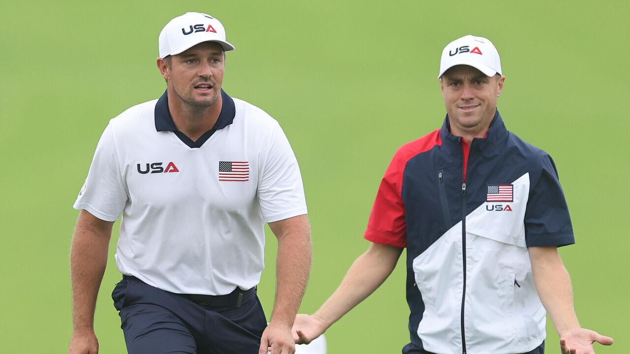 FARMINGDALE, NEW YORK - SEPTEMBER 25: Bryson DeChambeau of Team United States looks on while Justin Thomas of Team United States reacts during a practice round prior to the Ryder Cup 2025 at Black Course at Bethpage State Park Golf Course on September 25, 2025 in Farmingdale, New York.