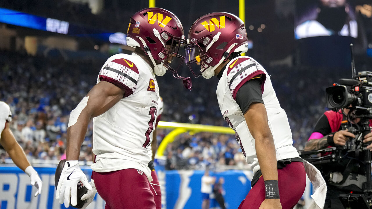 DETROIT, MICHIGAN - JANUARY 18: Terry McLaurin #17 of the Washington Commanders celebrates with Jayden Daniels #5 after catching a pass for a touchdown during the second quarter against the Detroit Lions in the NFC Divisional Playoff at Ford Field on January 18, 2025 in Detroit, Michigan.