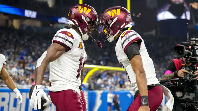 DETROIT, MICHIGAN - JANUARY 18: Terry McLaurin #17 of the Washington Commanders celebrates with Jayden Daniels #5 after catching a pass for a touchdown during the second quarter against the Detroit Lions in the NFC Divisional Playoff at Ford Field on January 18, 2025 in Detroit, Michigan.