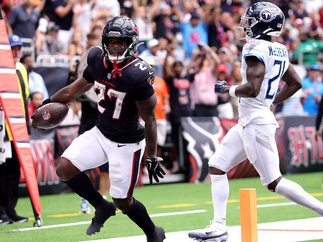 HOUSTON, TEXAS - SEPTEMBER 28: Woody Marks #27 of the Houston Texans scores a touchdown against Roger McCreary #21 of the Tennessee Titans during the fourth quarter in the game at NRG Stadium on September 28, 2025 in Houston, Texas.