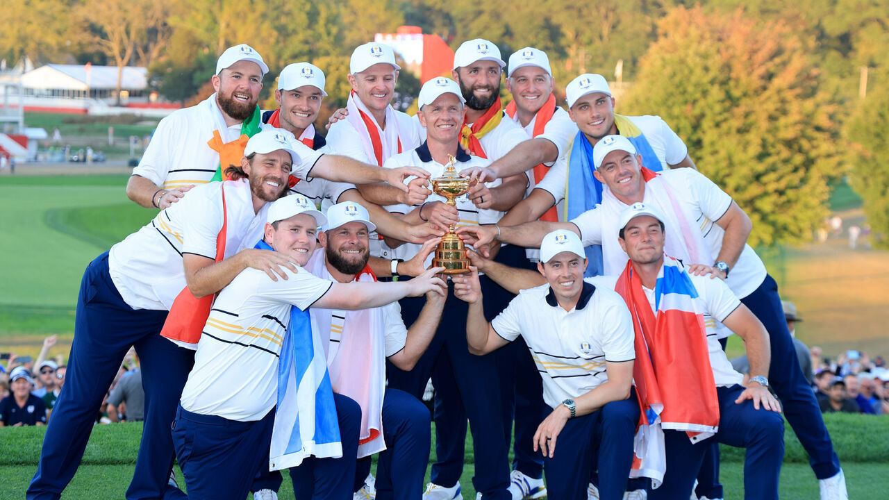 FARMINGDALE, NEW YORK - SEPTEMBER 28: Europe Captain Luke Donald, Shane Lowry, Rasmus Hojgaard, Justin Rose, Jon Rahm, Sepp Straka, Ludvig Aberg, Rory McIlroy, Viktor Hovland, Matt Fitzpatrick, Tommy Fleetwood, Robert MacIntyre and Tyrrell Hatton of Team Europe hold the Ryder Cup trophy after their 15-13 victory during the trophy presentation ceremony following the Sunday singles matches of the 2025 Ryder Cup at Black Course at Bethpage State Park Golf Course on September 28, 2025 in Farmingdale, New York.