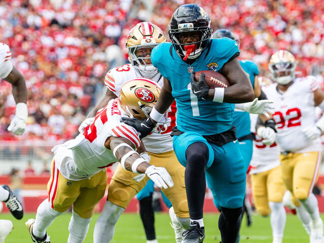 SANTA CLARA, CA - SEPTEMBER 28: Jacksonville Jaguars running back Travis Etienne Jr. (1) breaks a tackle for a touchdown in the second quarter of a NFL game against the San Francisco 49ers on September 28, 2025 at Levi's Stadium in Santa Clara, CA.