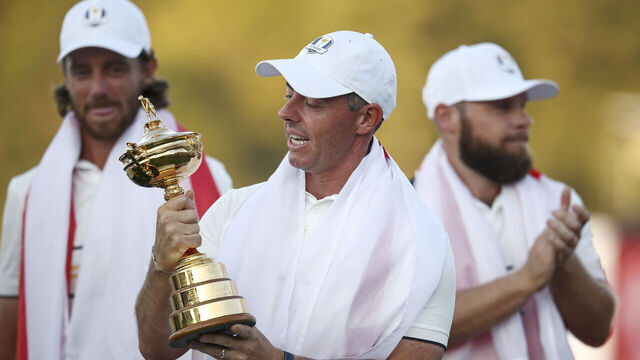 FARMINGDALE, NEW YORK - SEPTEMBER 28: Rory McIlroy of Team Europe holds the Ryder Cup trophy as Team Europe celebrates their 15-13 win over Team United States during the trophy presentation ceremony during the Sunday singles matches of the 2025 Ryder Cup at Black Course at Bethpage State Park Golf Course on September 28, 2025 in Farmingdale, New York.