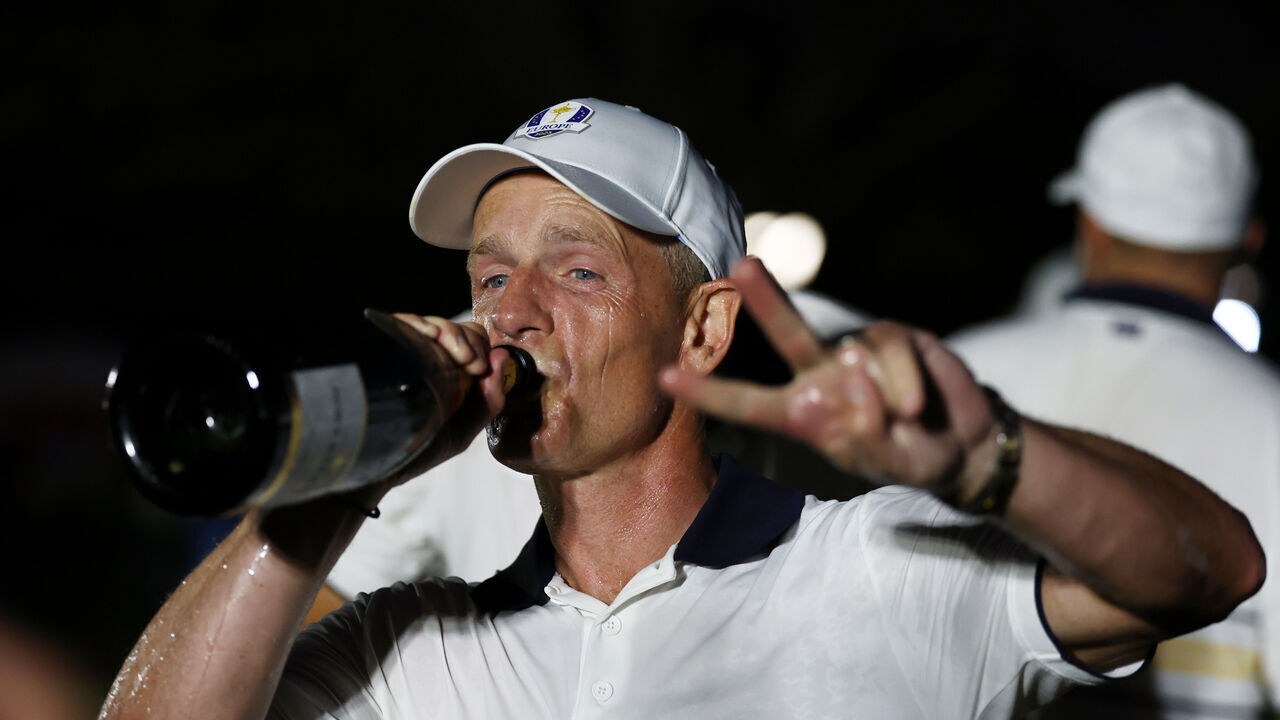 FARMINGDALE, NEW YORK - SEPTEMBER 28: Captain Luke Donald of Team Europe celebrates drinking champagne after Team Europe defeated Team United States 15-13 during the Sunday singles matches of the 2025 Ryder Cup at Black Course at Bethpage State Park Golf Course on September 28, 2025 in Farmingdale, New York.